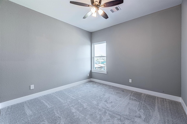 spare room featuring carpet floors and ceiling fan