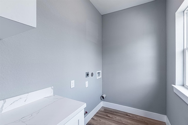 washroom featuring hardwood / wood-style flooring, gas dryer hookup, washer hookup, and hookup for an electric dryer