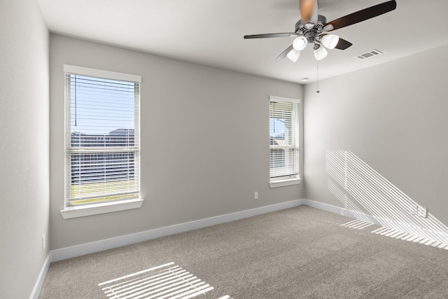 spare room featuring ceiling fan and light carpet