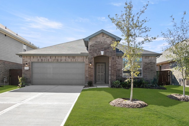 french country inspired facade with brick siding, an attached garage, a front yard, and driveway