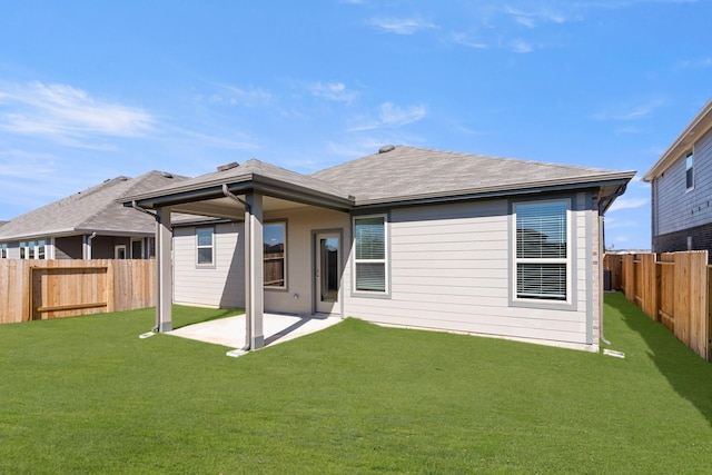 back of house featuring a yard, a patio, and a fenced backyard