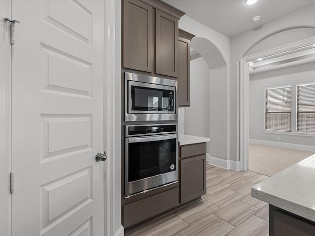 kitchen with dark brown cabinets and stainless steel appliances