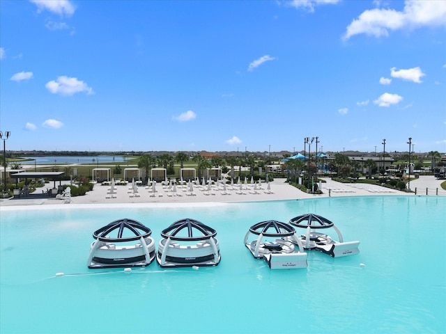 view of swimming pool with a water view