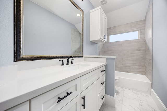 full bathroom with vanity, tiled shower / bath, vaulted ceiling, and toilet