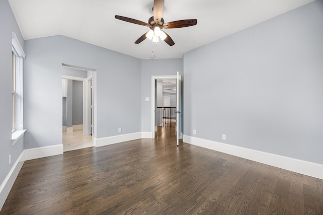 unfurnished bedroom with lofted ceiling, dark wood-type flooring, and ceiling fan