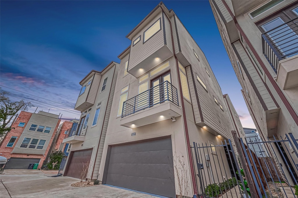 exterior space featuring a balcony and a garage