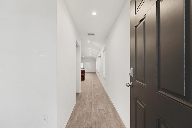 hallway with light hardwood / wood-style flooring