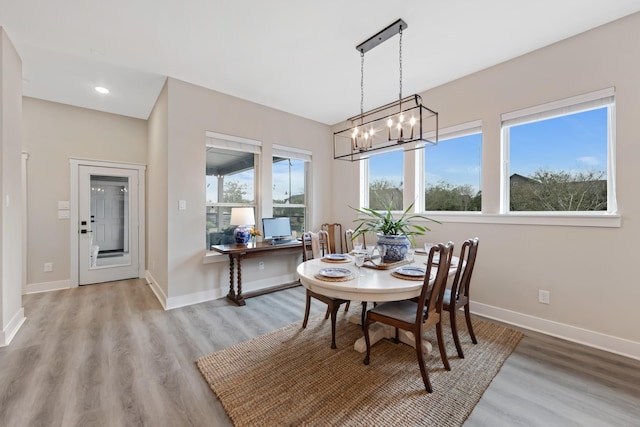 dining area featuring a notable chandelier and light hardwood / wood-style flooring