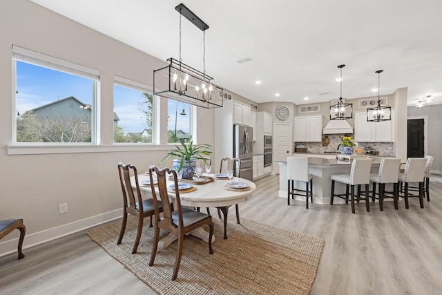 dining space with light hardwood / wood-style floors