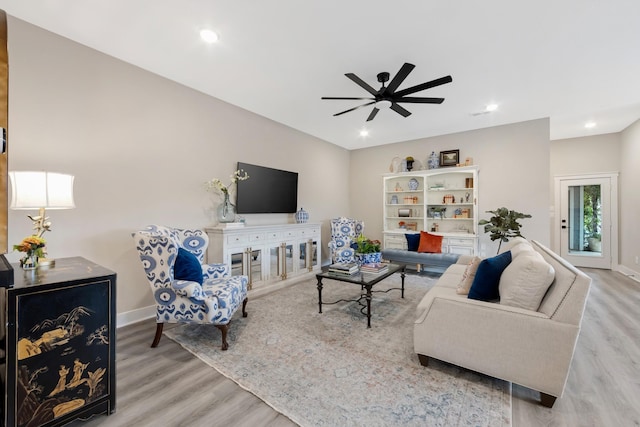 living room featuring ceiling fan and light wood-type flooring