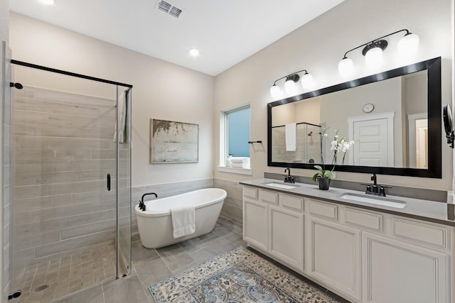 bathroom with vanity, plus walk in shower, and tile patterned flooring