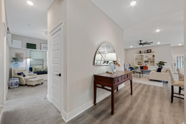 corridor with hardwood / wood-style flooring