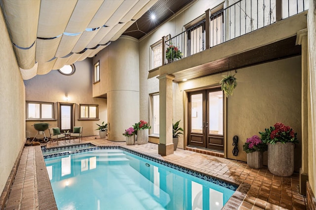 view of swimming pool featuring french doors