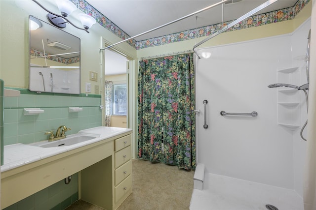 bathroom with tasteful backsplash, a stall shower, and vanity