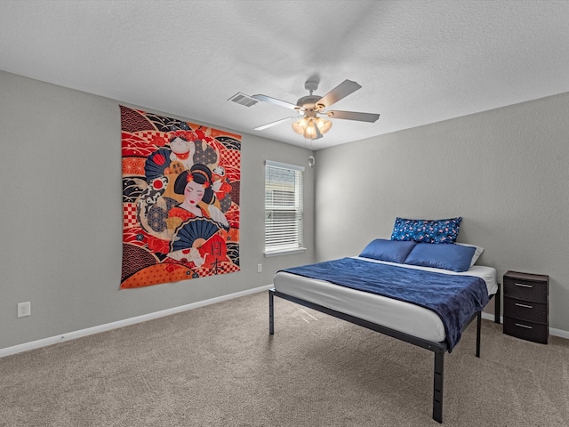 bedroom featuring carpet flooring, a textured ceiling, and ceiling fan