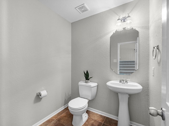 bathroom with tile patterned floors and toilet