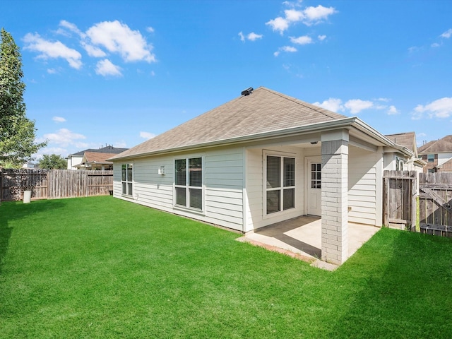 back of property with a patio and a yard