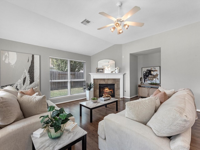 living room with ceiling fan, a fireplace, lofted ceiling, and dark hardwood / wood-style flooring