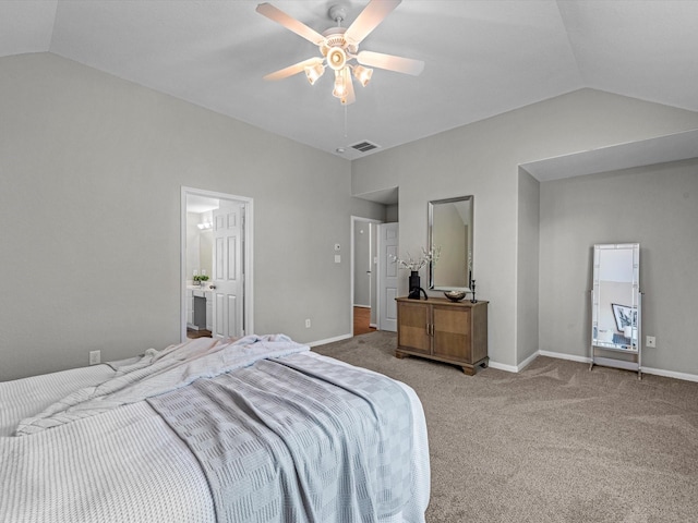 bedroom with ceiling fan, lofted ceiling, connected bathroom, and carpet floors