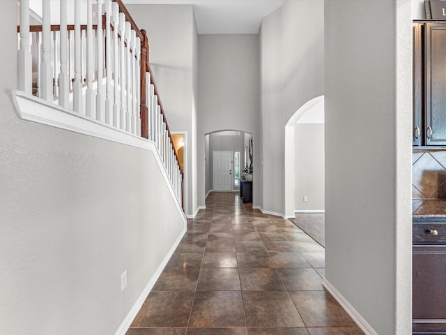 tiled foyer featuring a towering ceiling