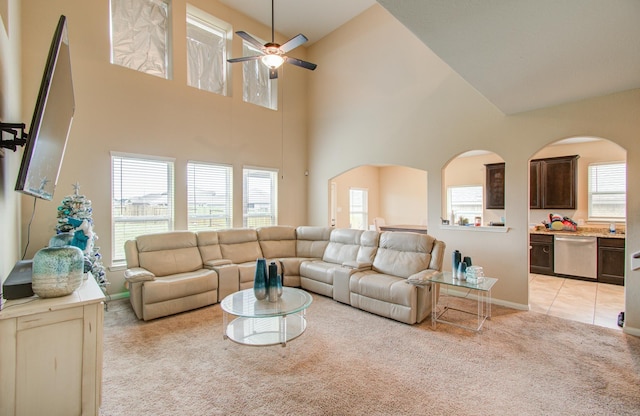 carpeted living room featuring a wealth of natural light and ceiling fan