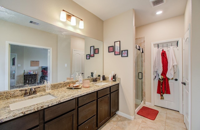 bathroom with vanity, an enclosed shower, and tile patterned flooring