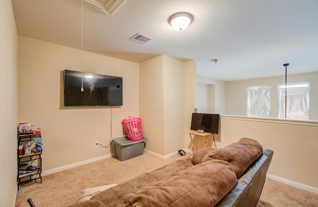 living room with light colored carpet and a textured ceiling