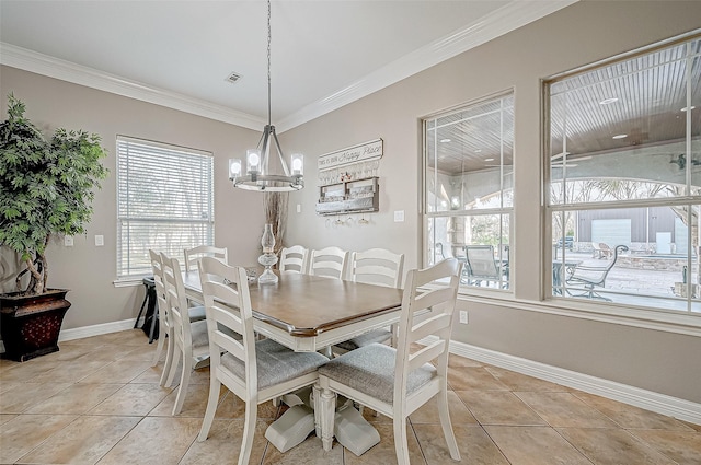 dining area featuring light tile patterned flooring, ornamental molding, and an inviting chandelier