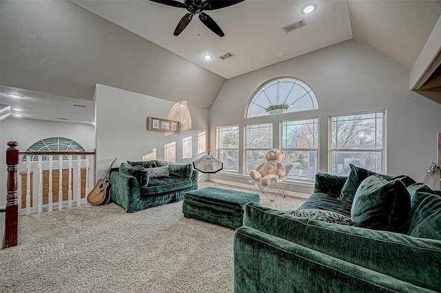 living room featuring vaulted ceiling, carpet floors, ceiling fan, and a textured ceiling