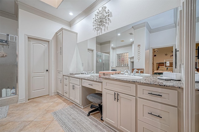 bathroom featuring vanity, a shower with door, tile patterned floors, and crown molding