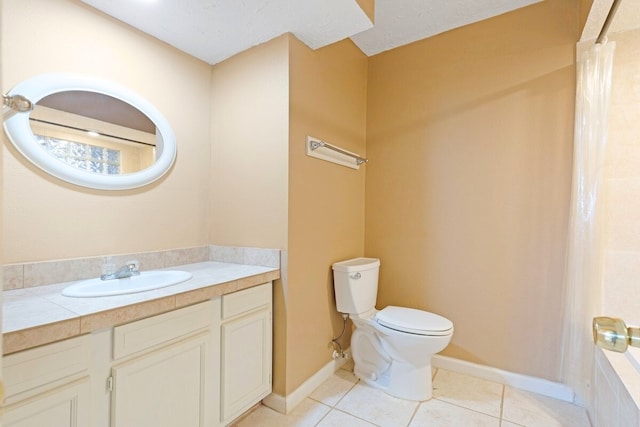 bathroom featuring tile patterned flooring, vanity, a tub, and toilet