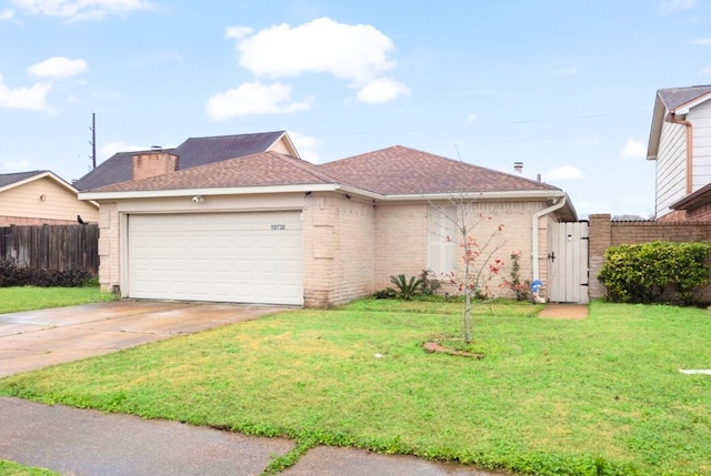 view of front of property with a garage and a front yard