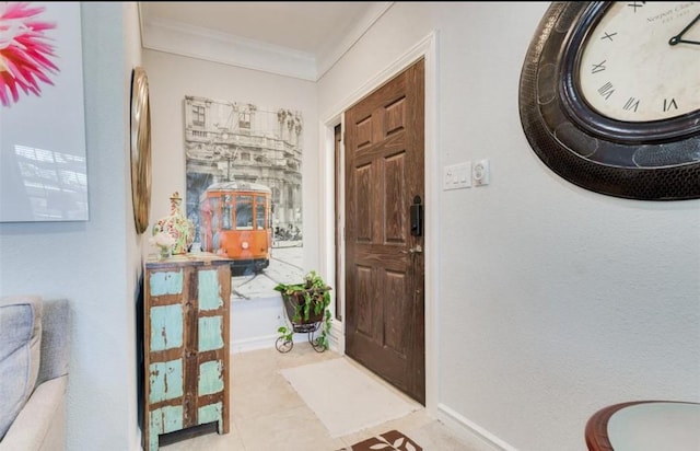 tiled foyer with ornamental molding