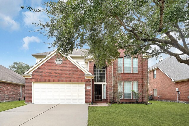 front of property with a garage and a front lawn