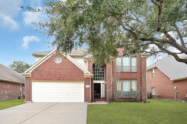 traditional-style house featuring a front yard, concrete driveway, brick siding, and an attached garage