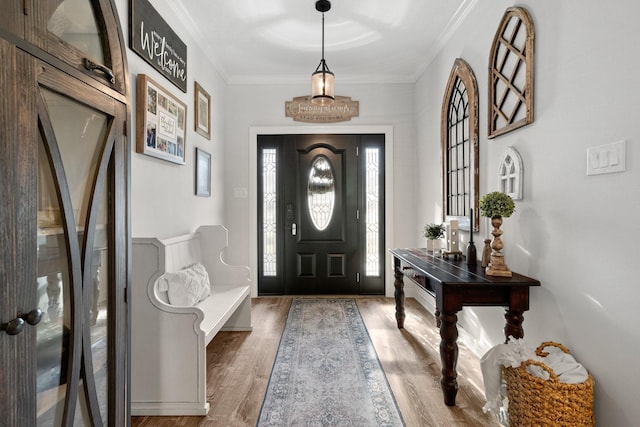 entrance foyer with dark hardwood / wood-style flooring and ornamental molding