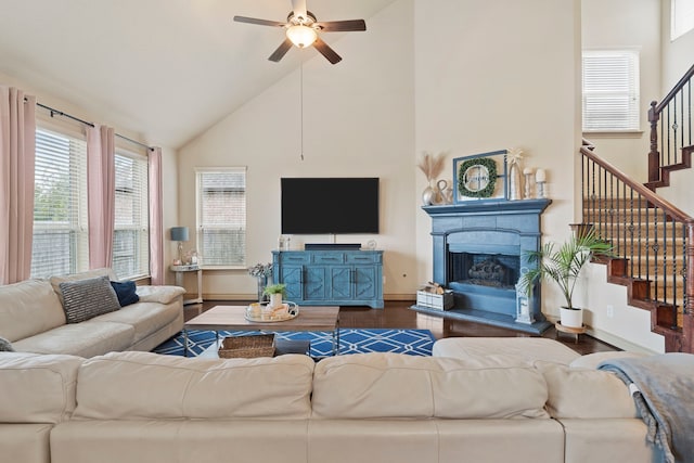 living room with hardwood / wood-style flooring, high vaulted ceiling, and ceiling fan