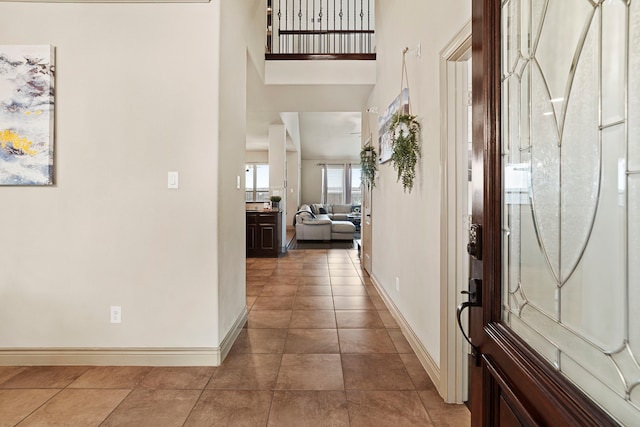 entrance foyer with a towering ceiling and tile patterned floors