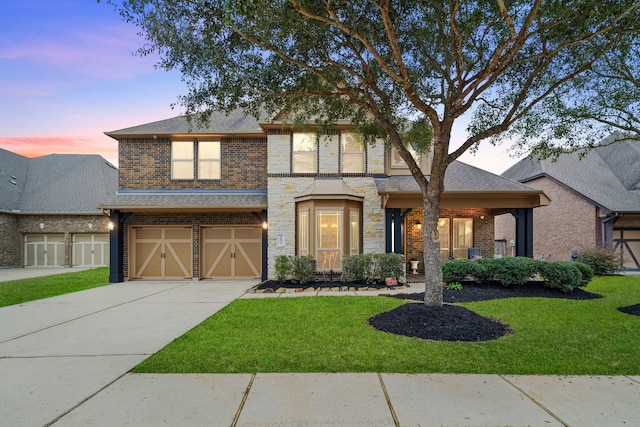 view of front of house with a garage and a yard