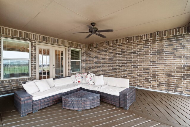 wooden deck with french doors, ceiling fan, and an outdoor living space