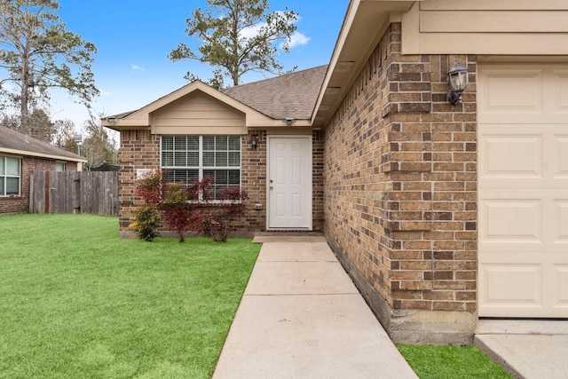 view of exterior entry featuring a lawn