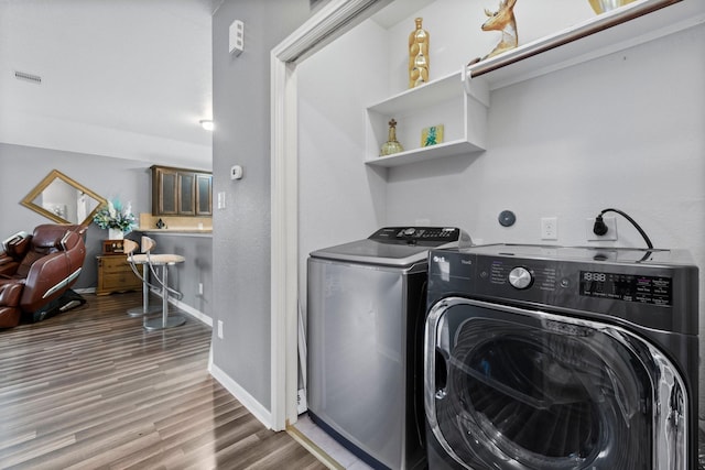 518 Lovers Ln, Dayton, TX 77535 - washroom with hardwood / wood-style flooring and separate washer and dryer