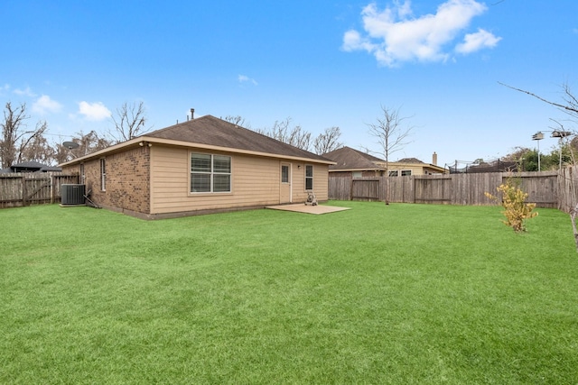 518 Lovers Ln, Dayton, TX 77535 - back of house featuring a yard, central AC unit, and a patio