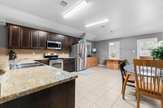518 Lovers Ln, Dayton, TX 77535 - kitchen featuring decorative light fixtures, sink, decorative backsplash, dark brown cabinetry, and stainless steel appliances