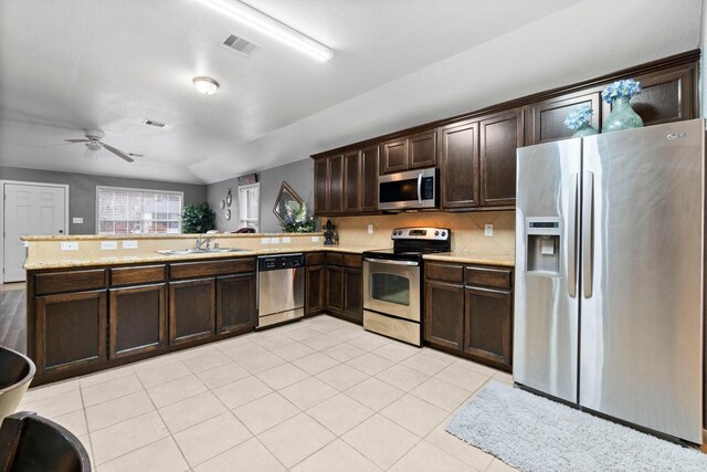 518 Lovers Ln, Dayton, TX 77535 - kitchen featuring stainless steel appliances, dark brown cabinets, and kitchen peninsula