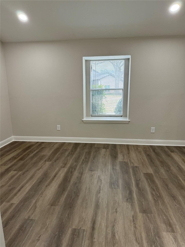 empty room with dark wood-type flooring