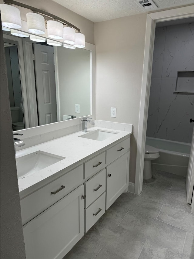 full bathroom featuring vanity, tub / shower combination, toilet, and a textured ceiling