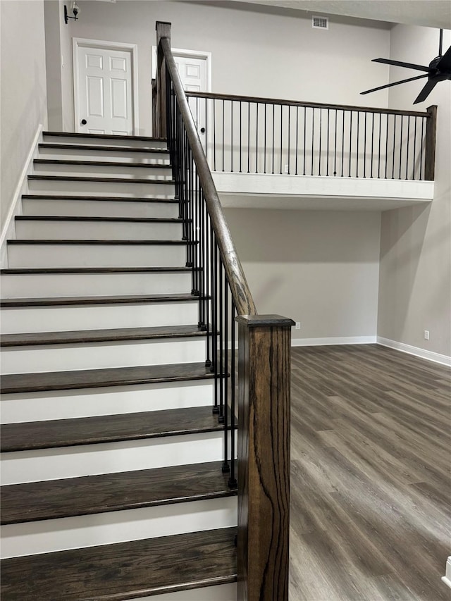 staircase featuring hardwood / wood-style flooring and ceiling fan