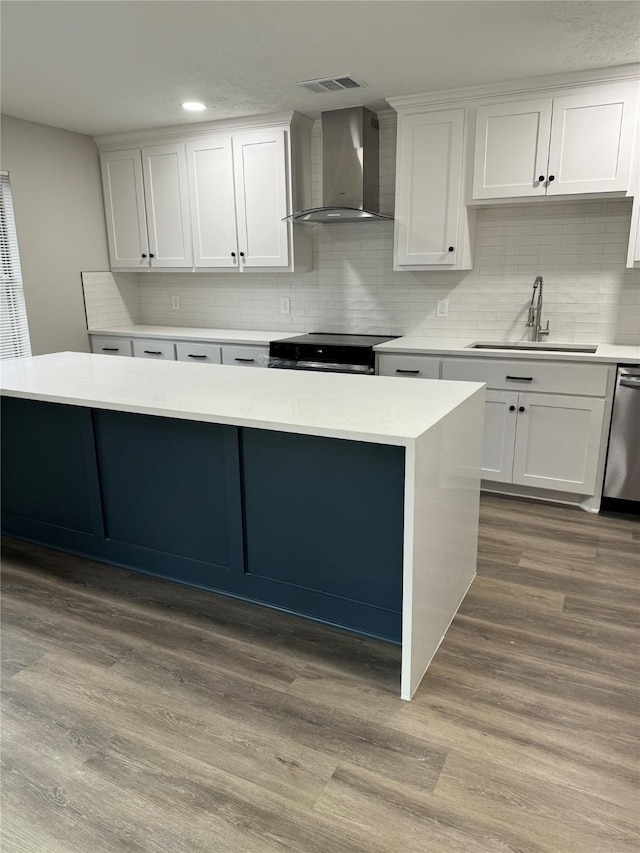 kitchen with sink, stainless steel dishwasher, electric stove, wall chimney range hood, and white cabinets