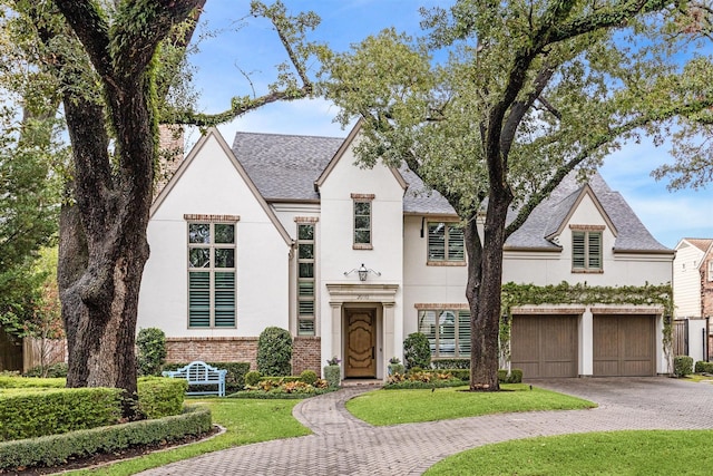 view of front of home featuring a garage and a front lawn